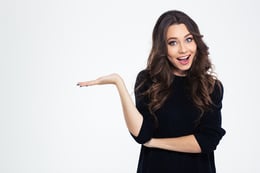 Portrait of a cheerful girl holding copyspace on the palm isolated on a white background